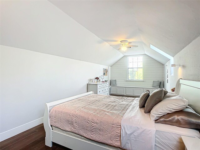 bedroom with ceiling fan, dark wood-type flooring, and lofted ceiling