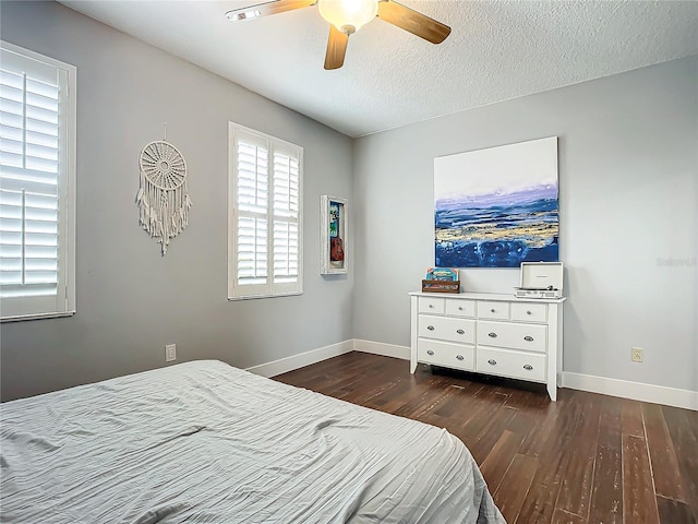 bedroom featuring a textured ceiling, ceiling fan, and dark wood-type flooring