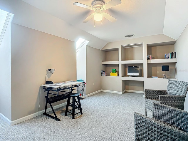 office area featuring built in shelves, ceiling fan, light colored carpet, and lofted ceiling