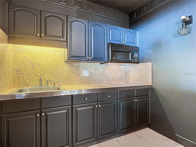 kitchen with light tile patterned floors, sink, and tasteful backsplash