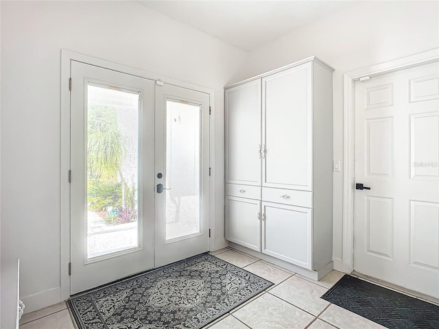 doorway featuring light tile patterned floors, a wealth of natural light, and french doors