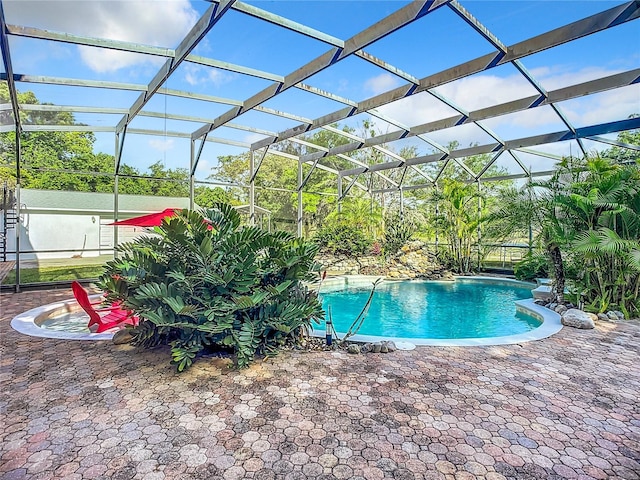 view of pool featuring a patio, pool water feature, and a lanai