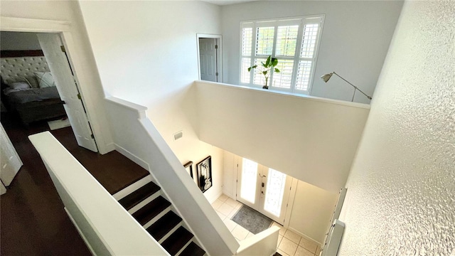 stairway featuring a wealth of natural light