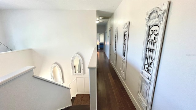 hallway with dark hardwood / wood-style flooring