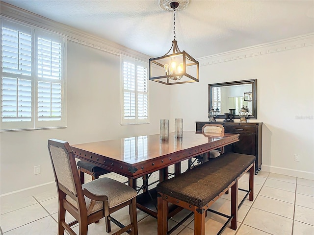 dining room featuring a chandelier, plenty of natural light, ornamental molding, and light tile patterned flooring