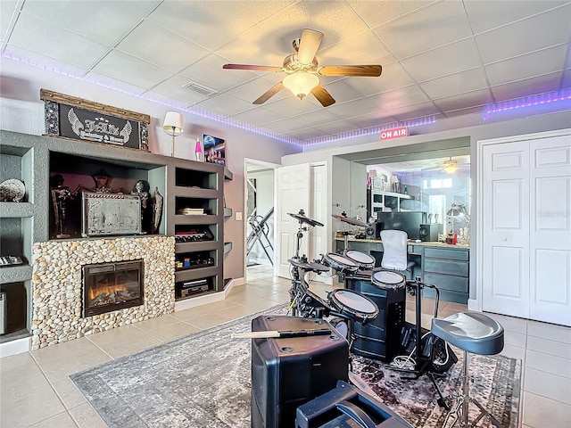 interior space featuring built in shelves, a paneled ceiling, and a fireplace