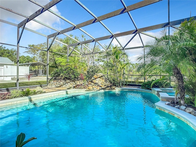 view of swimming pool featuring glass enclosure