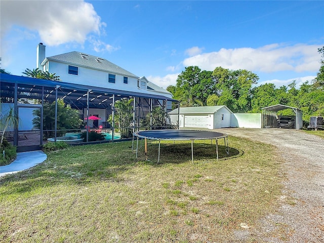 view of yard featuring a carport and a trampoline