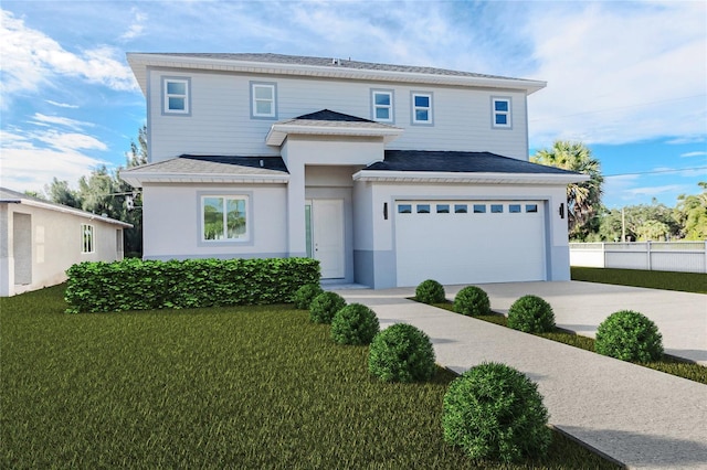 view of front of property with a garage and a front lawn