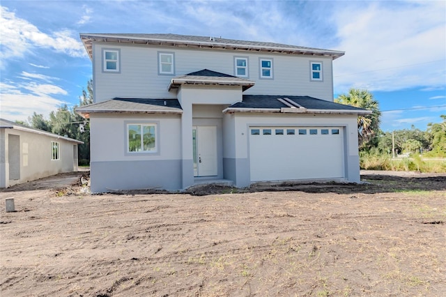 back of house featuring a garage