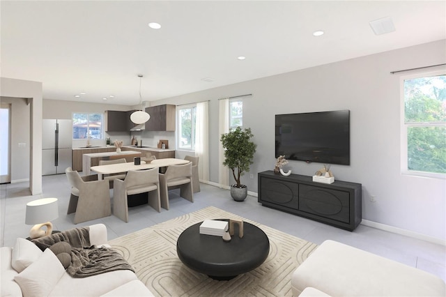 tiled living room with a wealth of natural light