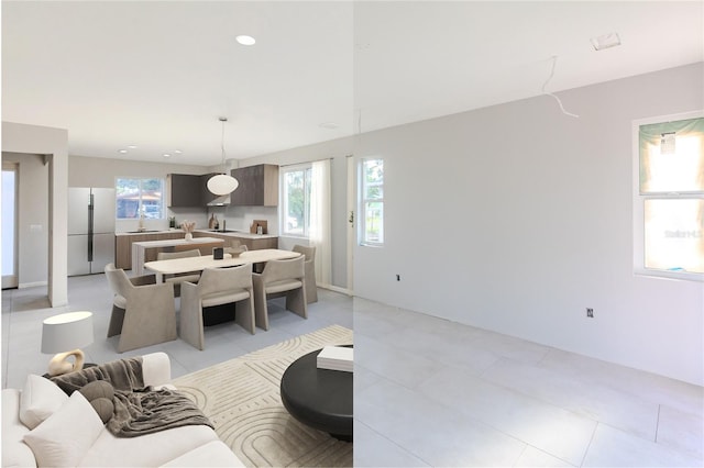 living room with light tile patterned floors and sink