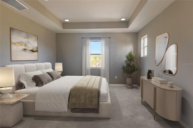 bedroom featuring light colored carpet, a tray ceiling, and multiple windows