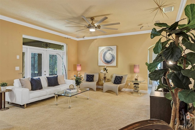 carpeted living room with ceiling fan, ornamental molding, a textured ceiling, and french doors