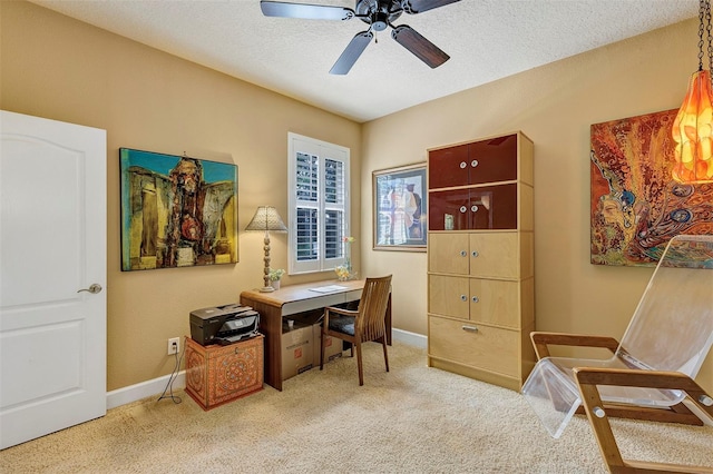 office space with light carpet, a textured ceiling, and ceiling fan