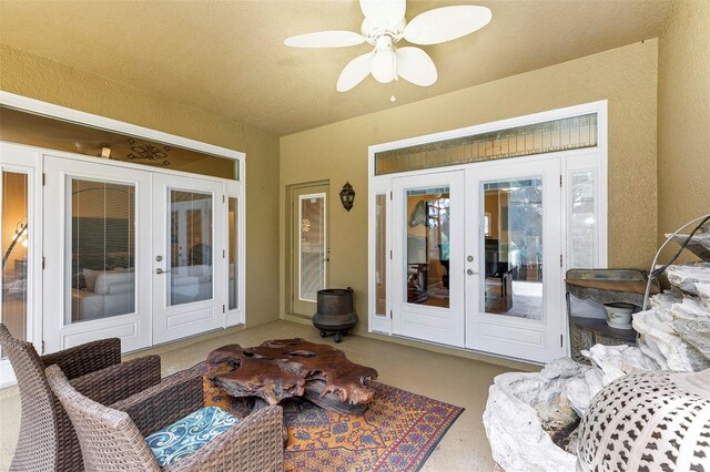 sunroom / solarium featuring french doors and ceiling fan