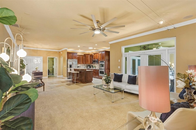 living room with ceiling fan and ornamental molding