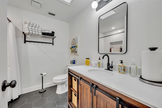 bathroom with tile patterned flooring, vanity, and toilet