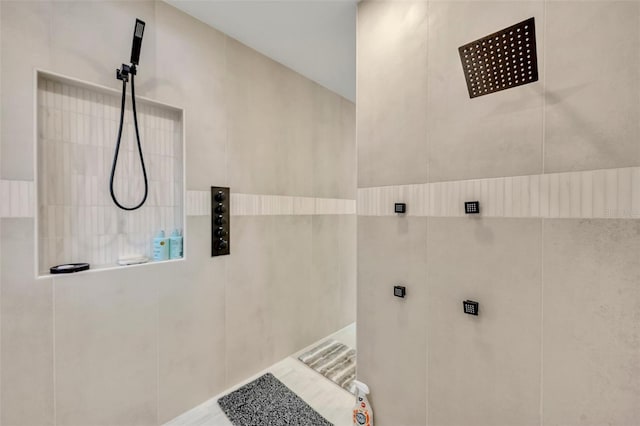 bathroom with a shower and tile walls