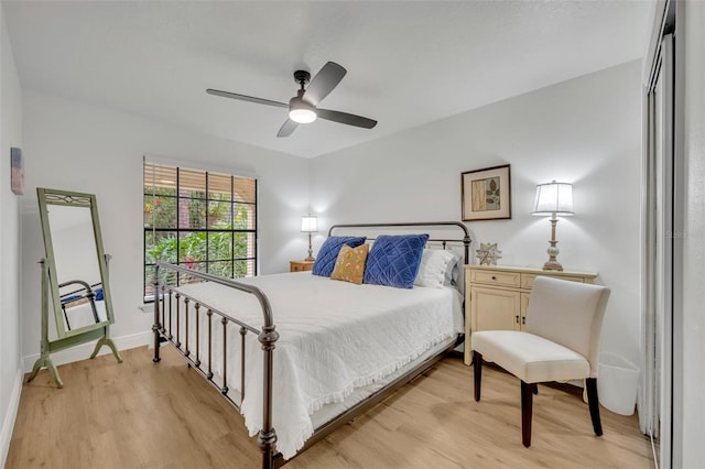 bedroom featuring a closet, light hardwood / wood-style flooring, and ceiling fan