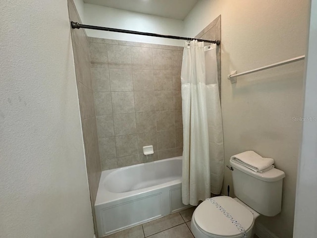 bathroom featuring tile patterned flooring, shower / bath combo, and toilet