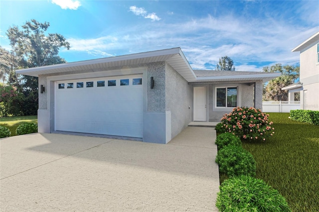 view of front facade with a garage and a front yard