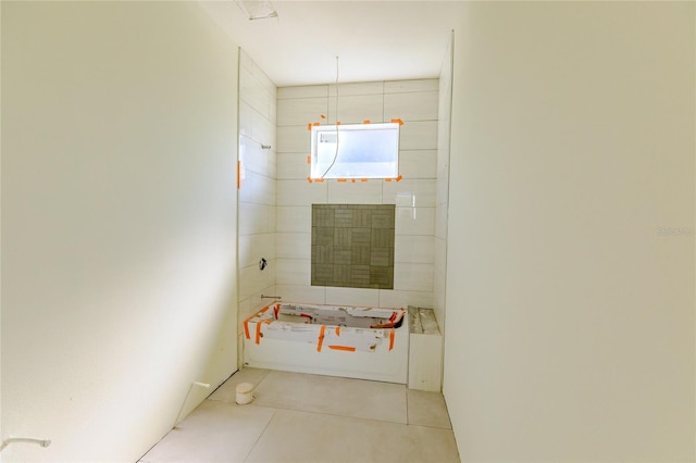 interior space with tile patterned flooring and a bathing tub