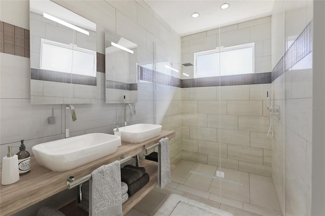 bathroom with vanity, tile walls, and tiled shower