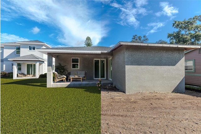 rear view of house featuring a patio area and a yard