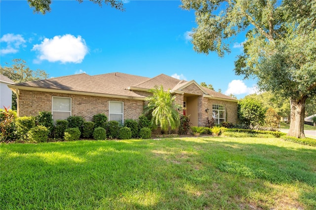 ranch-style home with a front lawn