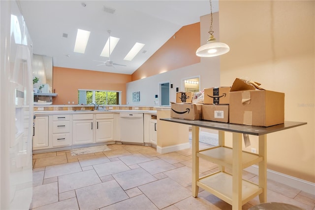 kitchen with high vaulted ceiling, a skylight, decorative light fixtures, white dishwasher, and ceiling fan