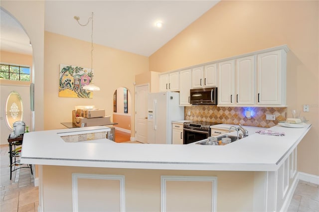 kitchen featuring white cabinets, sink, kitchen peninsula, appliances with stainless steel finishes, and decorative backsplash