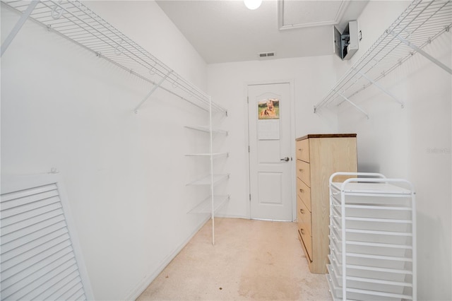 walk in closet featuring light carpet