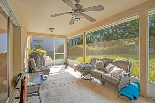 sunroom with a wealth of natural light and ceiling fan