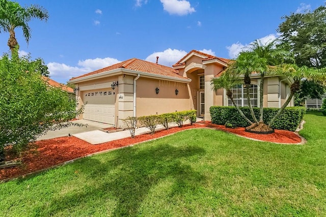 mediterranean / spanish-style home with a front yard and a garage