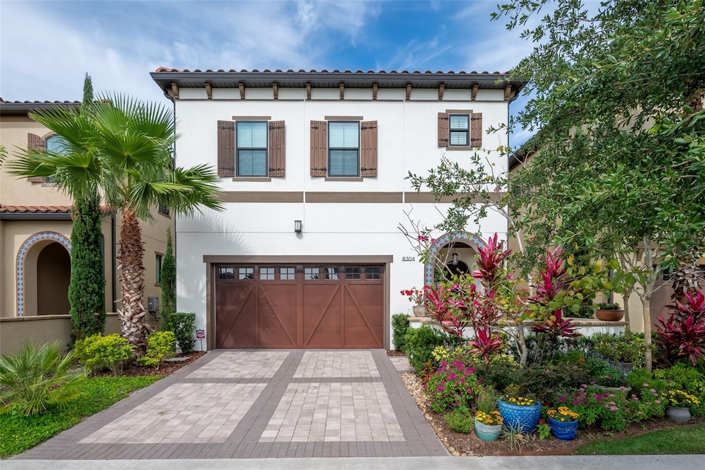 mediterranean / spanish-style house with a garage