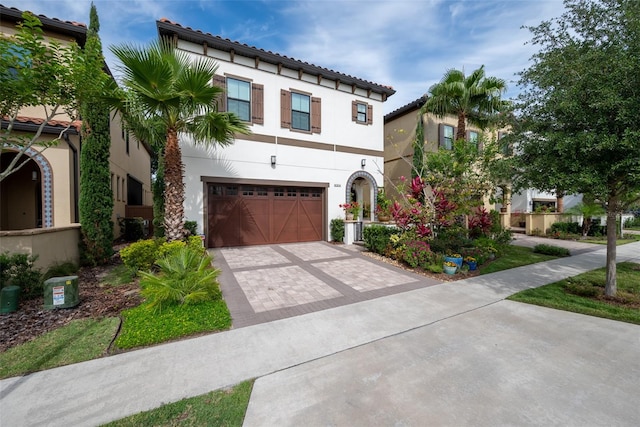 mediterranean / spanish house featuring a garage