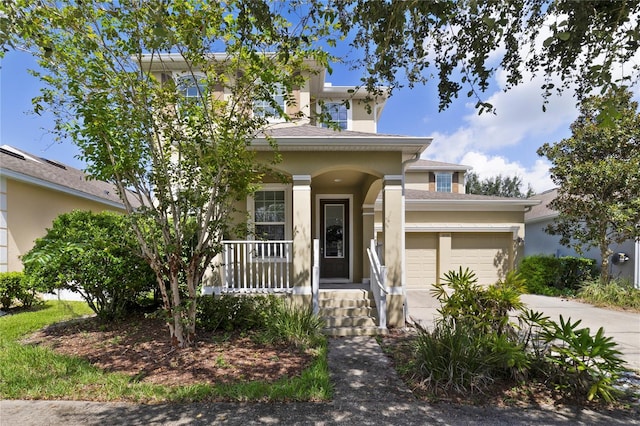 view of front facade featuring covered porch and a garage