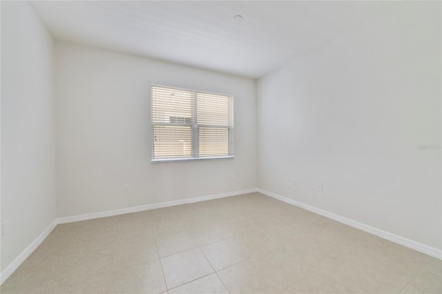 unfurnished room featuring light tile patterned floors