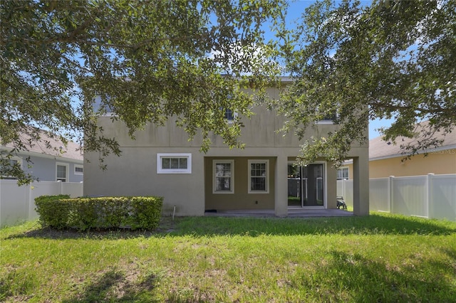 rear view of house with a lawn