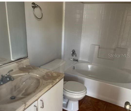 full bathroom with bathing tub / shower combination, vanity, and toilet