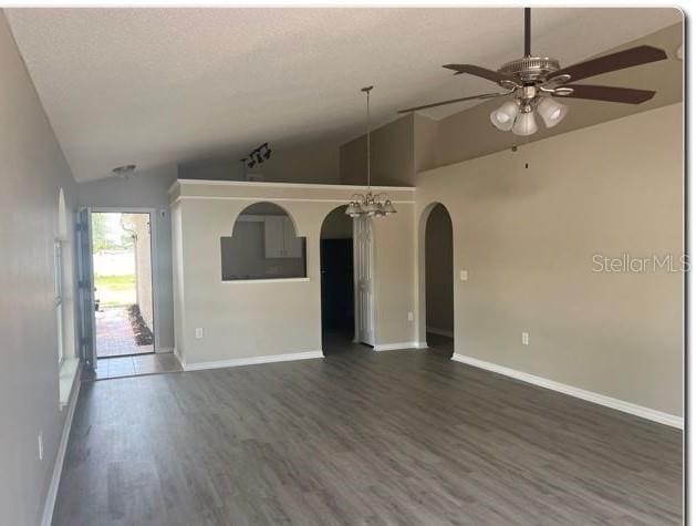 spare room featuring ceiling fan, a textured ceiling, dark hardwood / wood-style flooring, and high vaulted ceiling