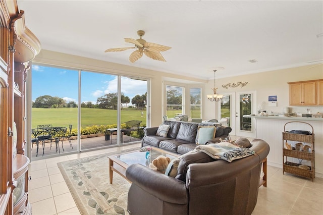 living room featuring ceiling fan with notable chandelier, ornamental molding, light tile patterned floors, and french doors