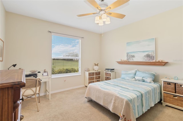 bedroom with a ceiling fan, carpet floors, and baseboards
