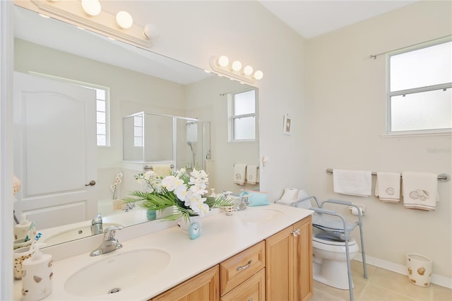 bathroom with vanity, plenty of natural light, toilet, and a shower with door