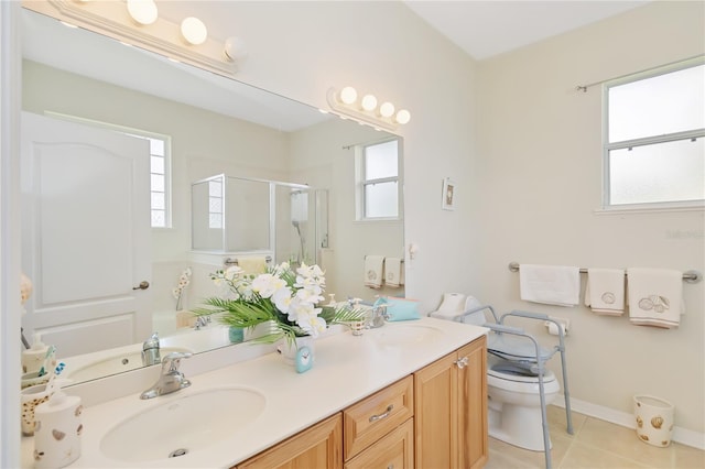 full bath featuring a wealth of natural light, a sink, a stall shower, and tile patterned floors