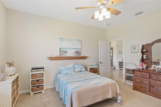 bedroom featuring a ceiling fan, light carpet, baseboards, and visible vents