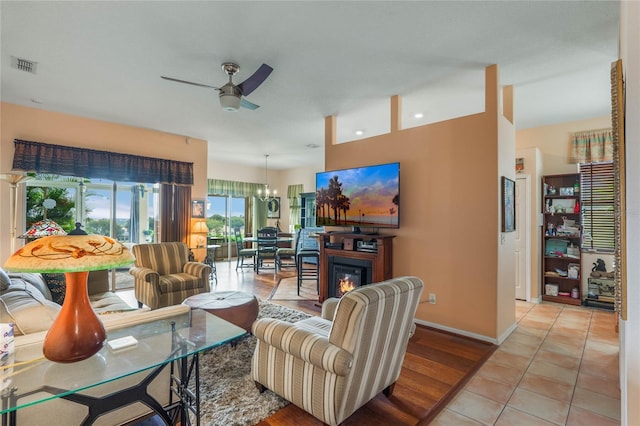 2366 Prairie Dunes, Clermont, FL 34711 - living area with light tile patterned floors, ceiling fan with notable chandelier, baseboards, and visible vents