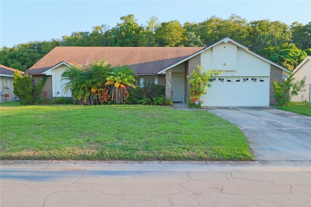 single story home featuring a front lawn and a garage