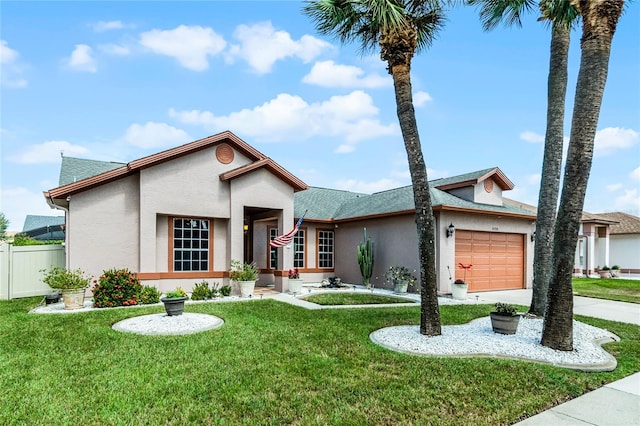 view of front of home with a front yard and a garage